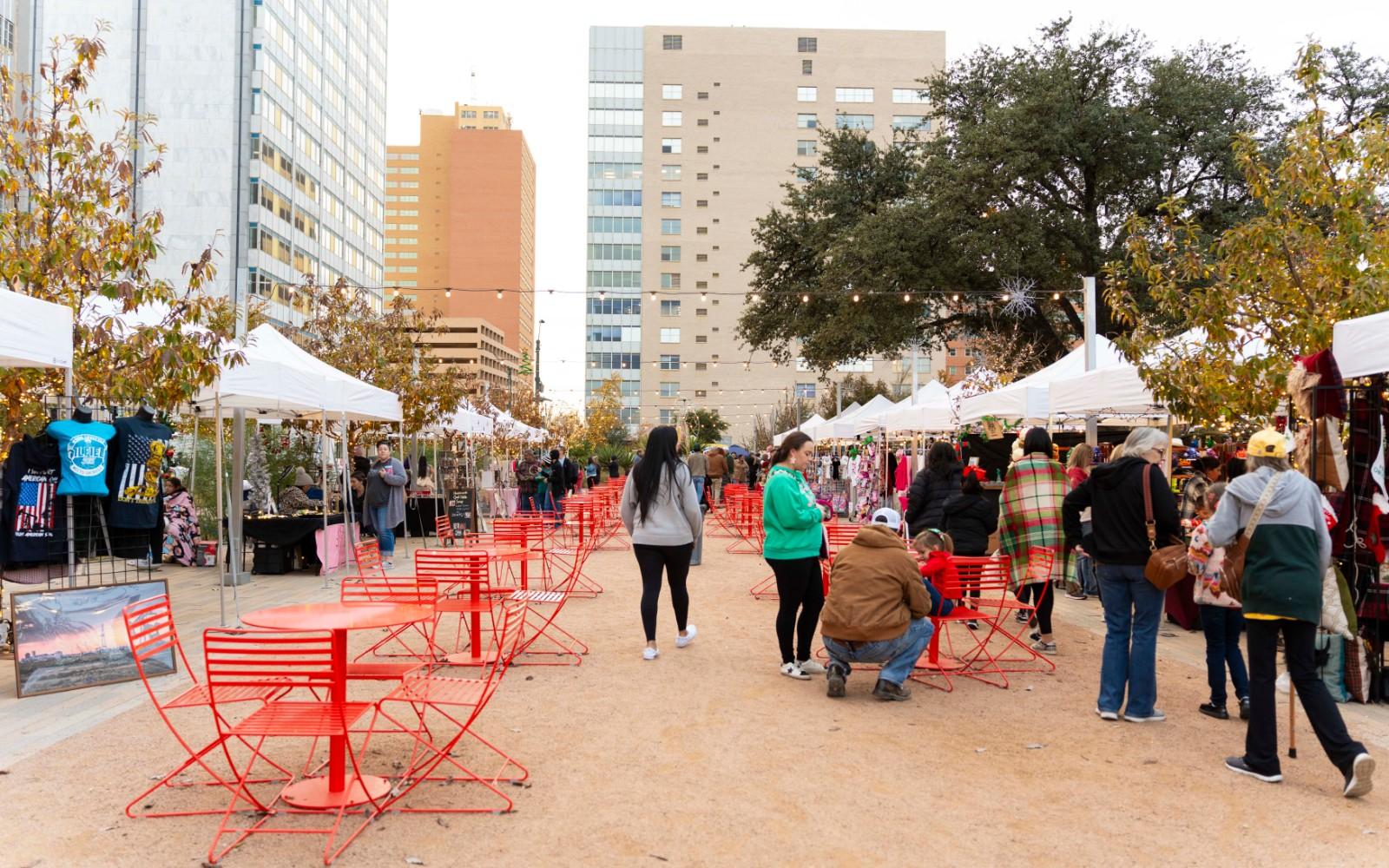 Visitors browsing vendor booths at the market.